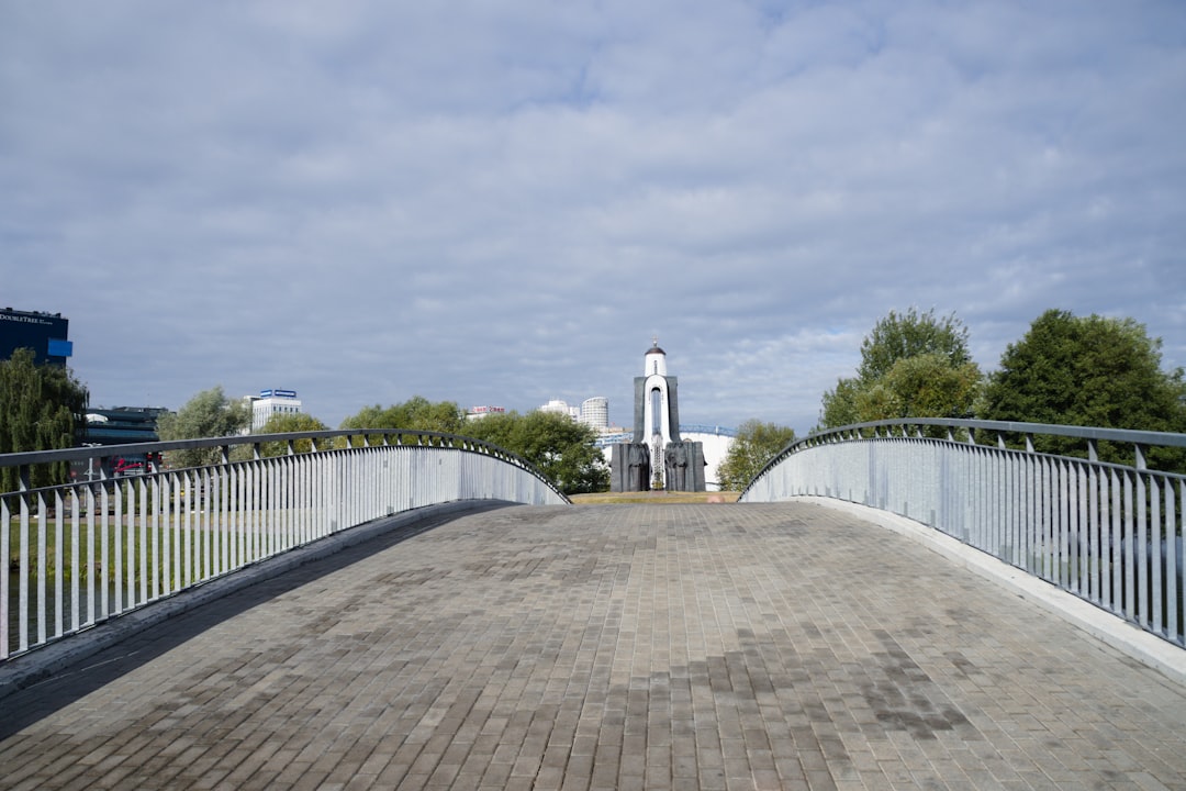 a bridge with a clock tower in the background